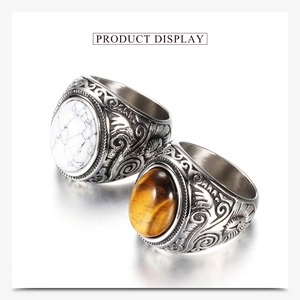 Detail of vintage steel rings with engraved patterns, white turquoise and tiger eye stone