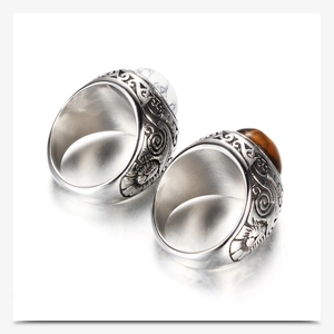 Detail of vintage 22mm stainless steel rings with marble and tiger eye stone inlay