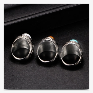 Macro detail of vintage stainless steel rings with marble and turquoise stone inlays