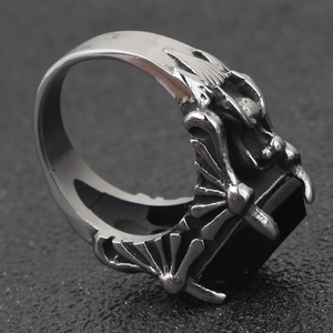 Gothic punk silver ring with a rectangular black gemstone held by dragon claw prongs