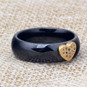 Black ceramic band ring featuring a gold-plated heart inset with micro-pave cubic zirconia