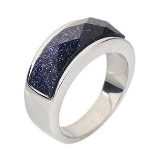 Detail of a faceted blue sandstone inlay on a polished stainless steel ring