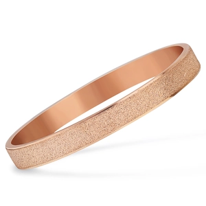 Detail of rose gold stainless steel bangle with frosted sandblasted texture and mirror finish
