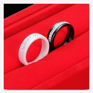 Detail of black and white ceramic rings with single row crystals in a red box