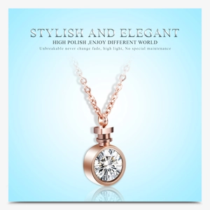 Close-up of rose gold necklace with large multi-faceted round sparkling diamond pendant