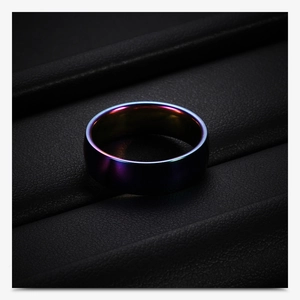 Macro shot of 6mm rainbow stainless steel ring on black textured leather display