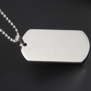 Polished stainless steel military dog tag pendant with beaded chain on black background