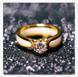 Detailed close-up of a 6mm ceramic ring with a gold band and sparkling center zircon