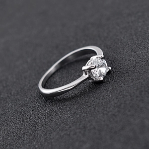 Macro shot of 6mm polished silver ring with round zirconia in classic four-prong setting