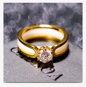 Macro view of gold ceramic ring with four-claw set sparkling round zirconia stone
