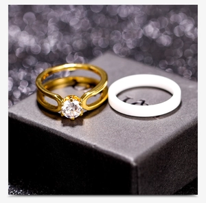 Detailed macro view of a 6mm white ceramic ring paired with a sparkling gold zircon ring