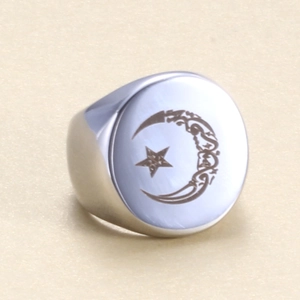 Macro shot of silver stainless steel signet ring with star moon laser engraving