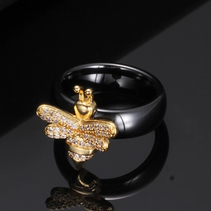 Anillo de cerámica negra de 6mm con abeja dorada y circonitas sobre espejo negro liso