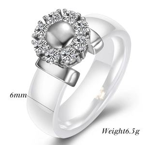Detail of 6mm white ceramic ring with a sparkling crystal flower top in silver finish