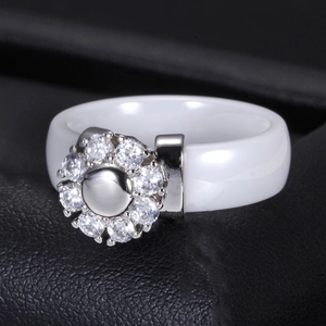 6MM white ceramic ring featuring a sparkling zircon sunflower center on textured background