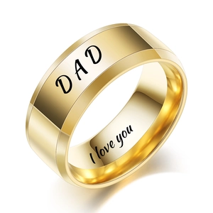 Macro shot of gold DAD ring with I love you engraving and polished metallic finish