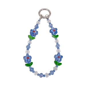 Close-up of blue glass plum blossom beads and metallic spring ring on phone charm