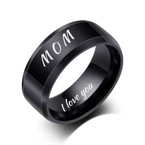 Detailed macro of black stainless steel ring featuring MOM and I love you engraving