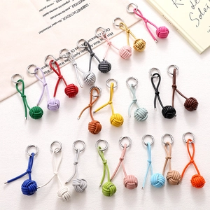 Colorful hand-woven leather ball keychains for handbags in nineteen different shades