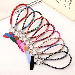 Detailed view of colorful Bohemian braided phone wrist straps with metal clasps and pads