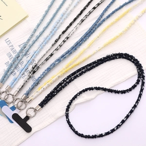 Close-up of colorful denim fabric phone straps with sequins and silver metal rings
