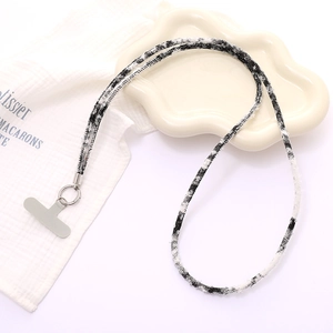 Close-up of black and white tweed phone lanyard with silver metal clasp and T-patch