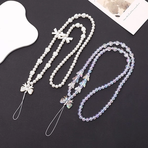 Detail of beaded mobile phone lanyards featuring white pearls and iridescent butterflies