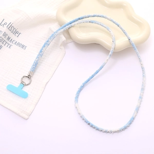 Close-up of blue denim woven phone lanyard with silver sequins and metal hook