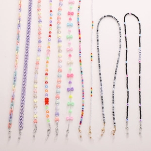 Various DIY phone lanyards with pearls, macaron beads, and metal lobster clasps