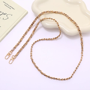 Detail of gold metal and brown leather woven chain strap with lobster clasps