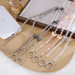 Three crystal beaded bag charms with metal butterfly pendants and silver ring clasps