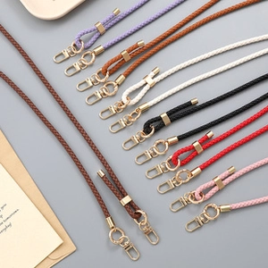 Detail of colorful braided mobile phone lanyards with premium golden metal clasps