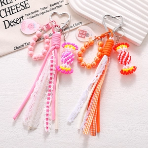 Detail of handmade beaded candy charms with heart clips and colorful fabric tassels