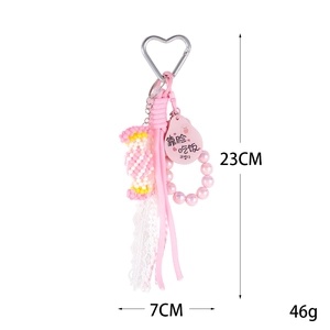 Pink woven candy bead charm with lace ribbon and heart-shaped metal hook for bags