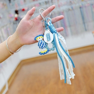 Handmade woven candy beaded phone charm with blue acrylic beads and lace ribbon