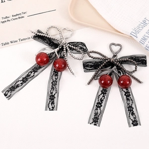 Lace bow cherry bag charm with red glitter finish and metal heart clasp accessory