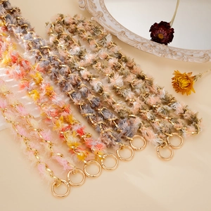 Detail of luxury braided metal chain with colorful plush ribbon and gold spring buckles