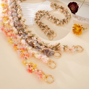 Macro detail of colorful plush woven strap with high-polish gold metal spring ring clasps