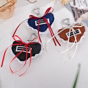 Denim heart charms with white lace trim and Wednesday labels in navy, black and brown