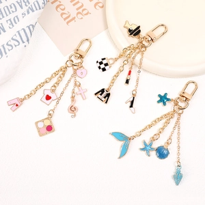 Detailed close-up of alloy bag pendants in pink fashion, black chic, and blue ocean themes