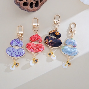 Handmade Chinese style gourd keychains in four colors with traditional silk fabric patterns