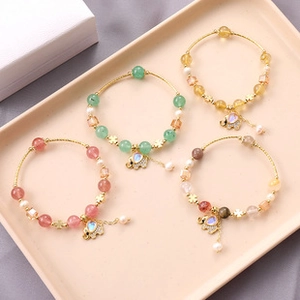 Detail of beaded bracelets with crystal elephant pendants and pearls in multiple colors