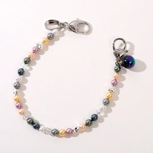 Detailed macro view of colorful pearl strap with silver heart clasps and beads