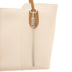 Elegant beige leather handbag featuring a luxurious rhinestone tassel keychain pendant