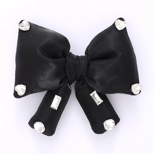 Elegant black satin bow accessory with sparkling crystal rhinestones for fashion decor