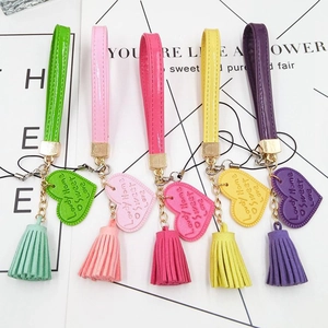 Set of five colorful PU leather heart tassels and fringe keychain charms in vibrant shades
