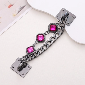 Macro view of gunmetal alloy chain with faceted rose red crystals for phone case