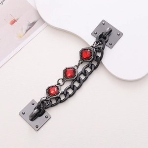 Detail of DIY phone case chain with black resin links and three square red gemstones