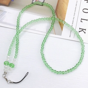 Detail of handmade green crystal beaded phone lanyard with metal lobster clasp and cord