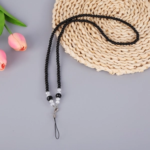 Macro detail of handmade black crystal beaded phone lanyard with silver lobster clasp